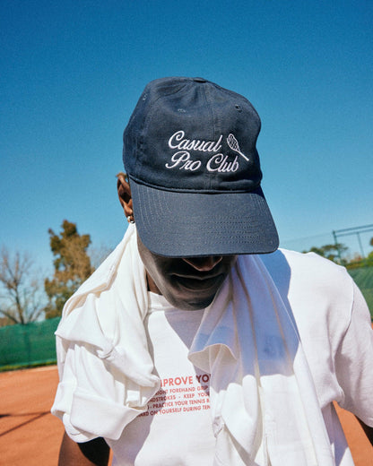 Man Wearing a navy embroidered Tennis dad hat
